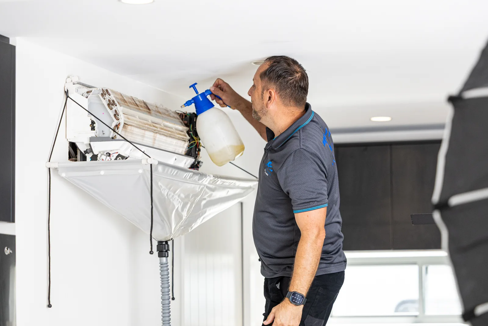 Coil cleaning rig set up on an air conditioning unit