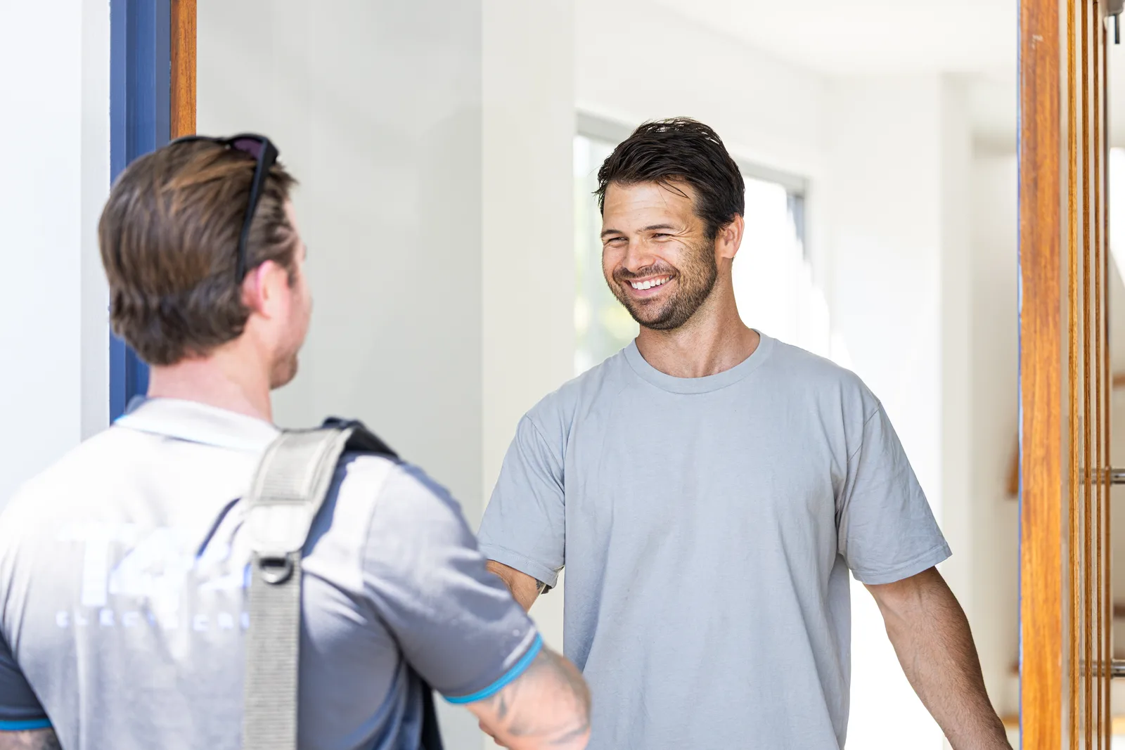 Technician greeting a customer at the front door