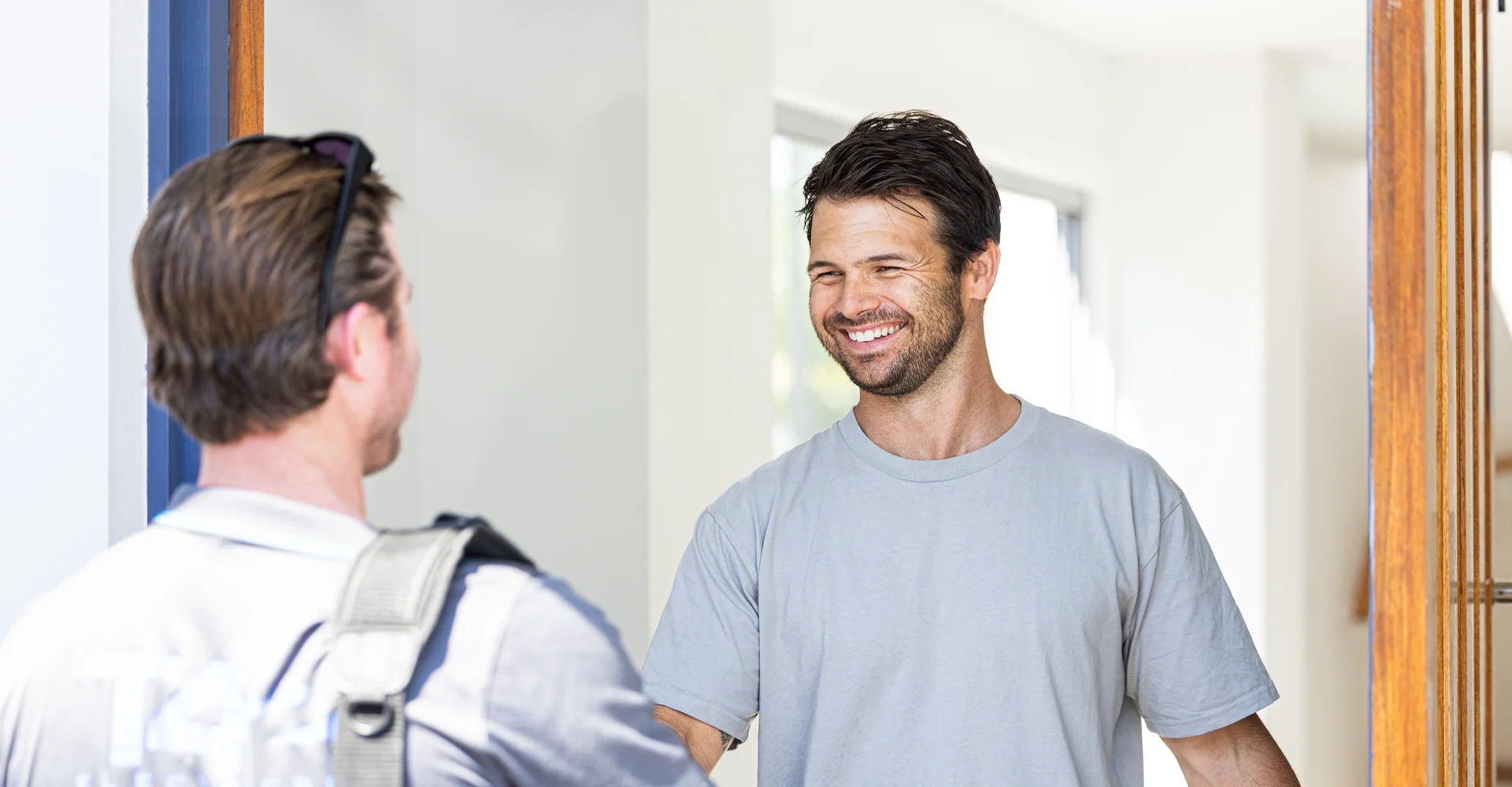 Licensed local air conditioning technician greeting a customer at the door