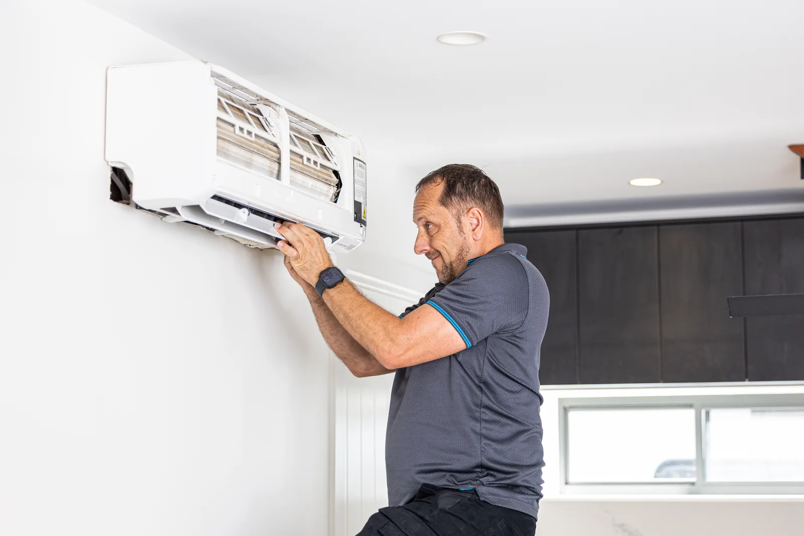 Technician checking the filters of a split system air conditioner