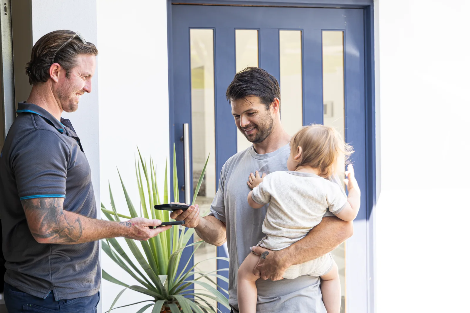 Technician meeting a customer and their family at the door